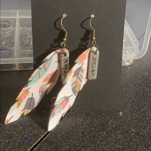 Faux leather earrings with charm